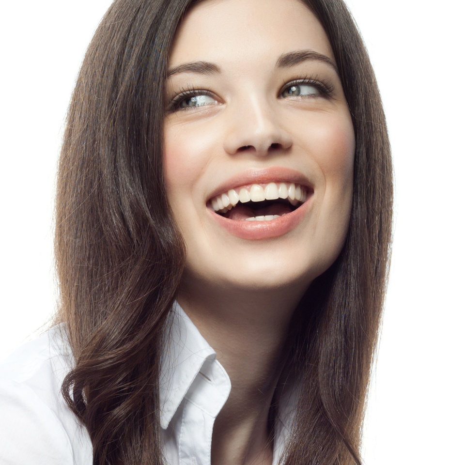 closeup portrait of attractive caucasian smiling woman brunette isolated on white studio shot lips toothy smile face hair head and shoulders tooth