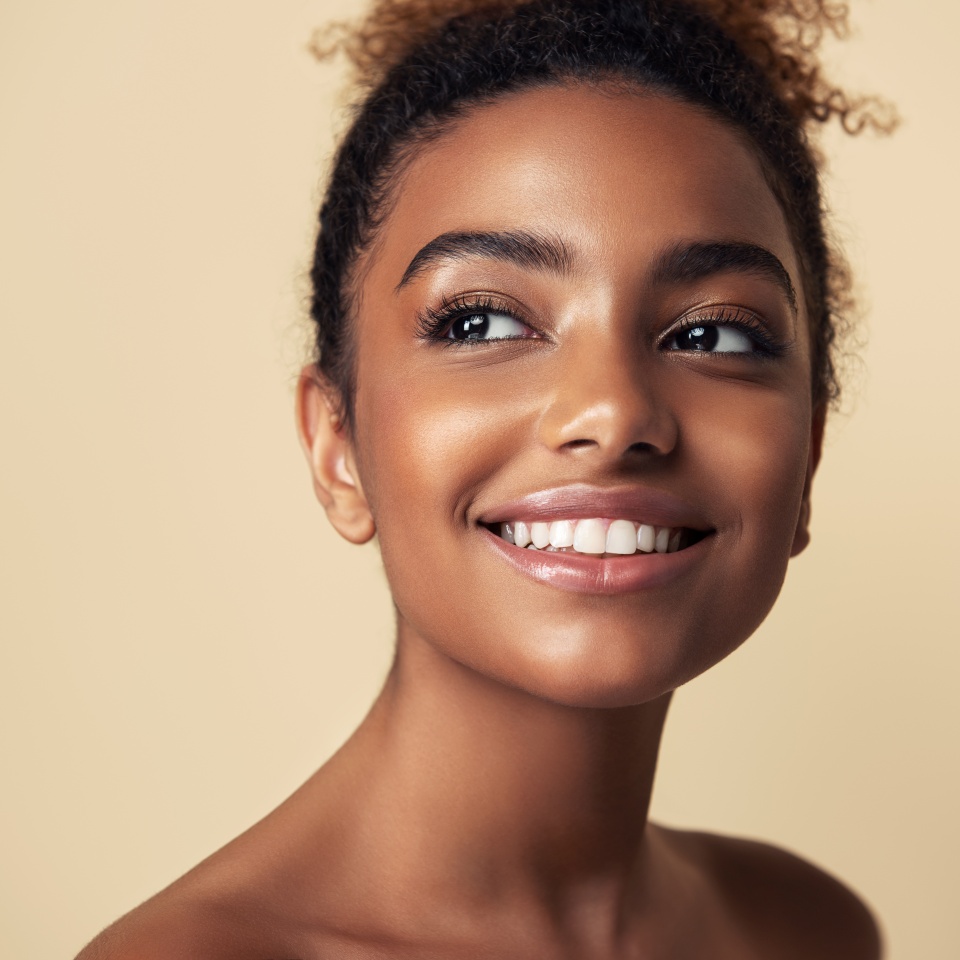 Beauty portrait of African American girl . Beautiful black woman touch her face . Facial treatment . Cosmetology , skin care and spa .