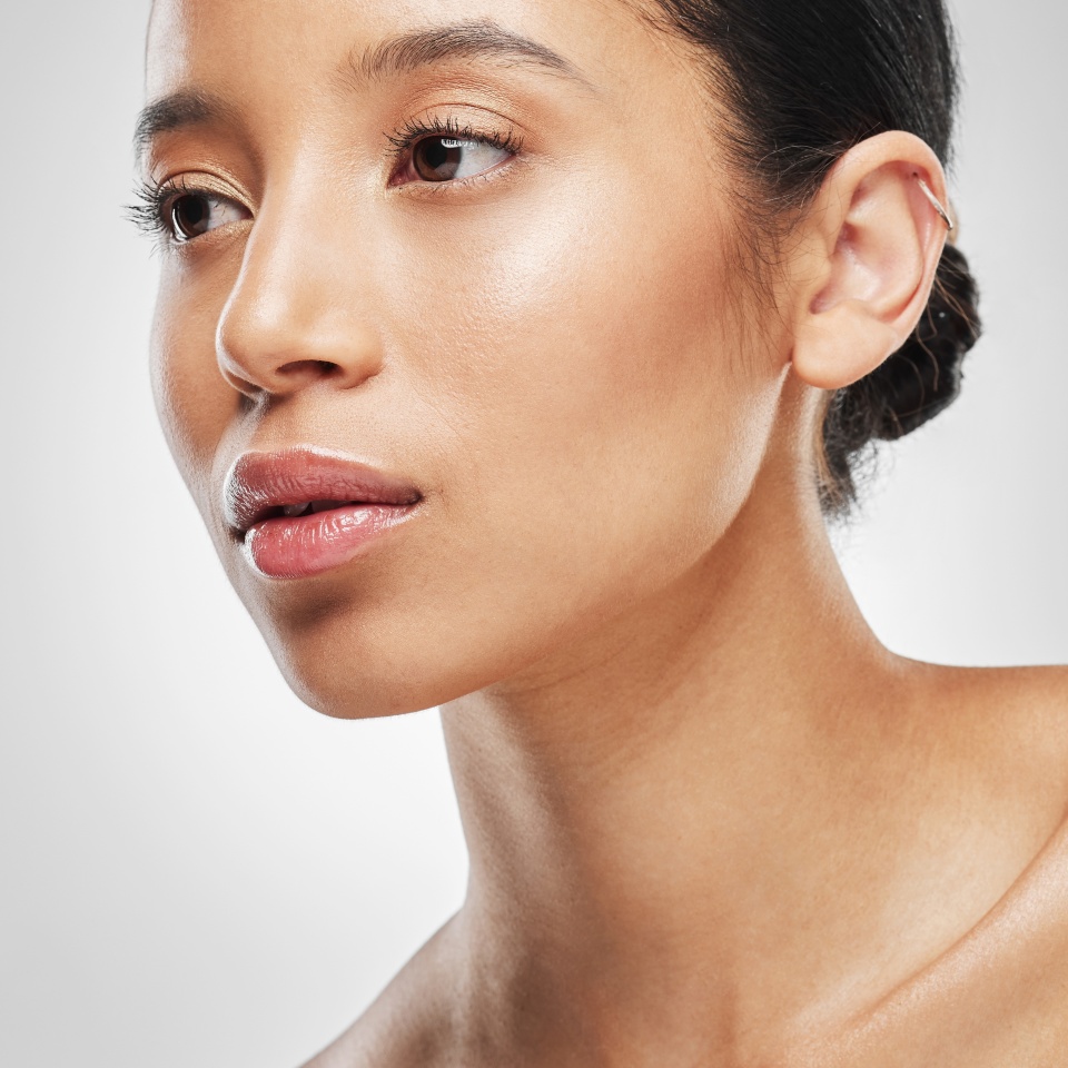 We all want that natural, healthy glow. Studio shot of an attractive young woman posing against a grey background.
