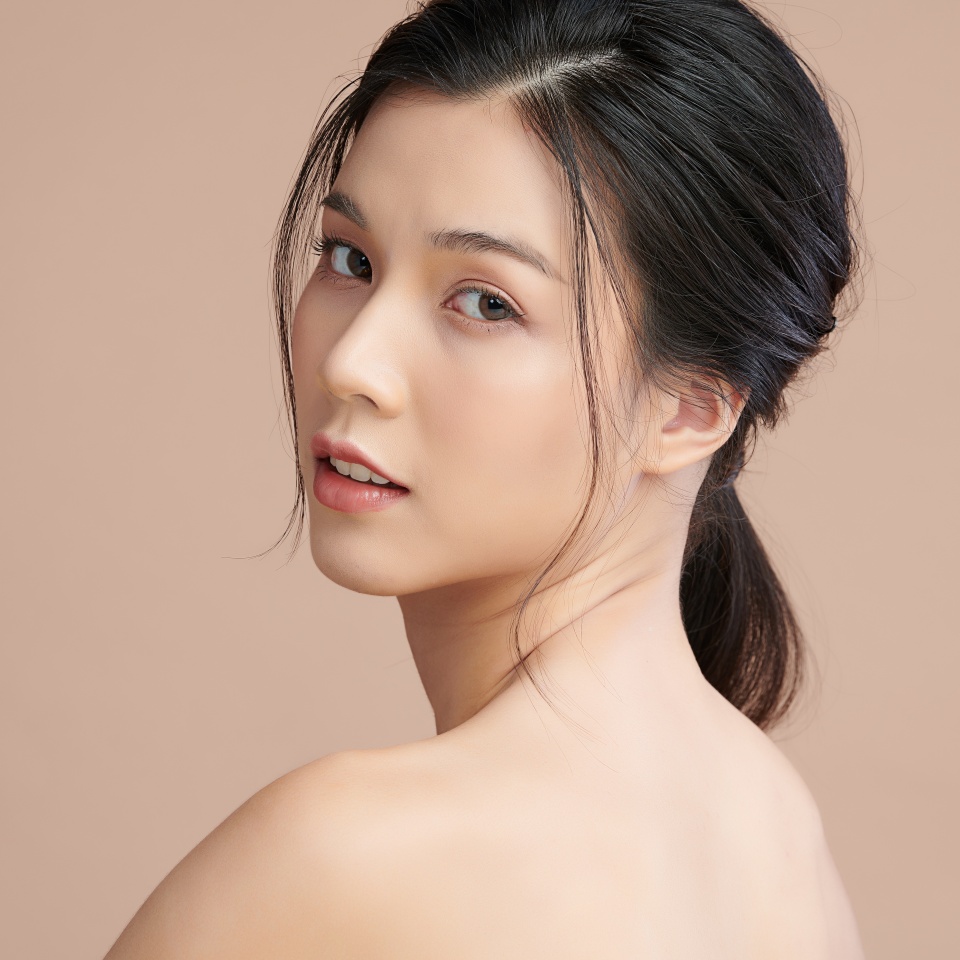 Beautiful young asian woman with clean fresh skin on beige background, Face care, Facial treatment, Cosmetology, beauty and spa, Asian women portrait.