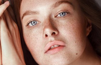 Skin care. Woman with beautiful freckles and healthy hydrated skin. Sensitive girl model with natural makeup. High quality image